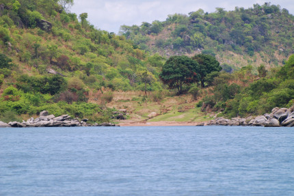 Lake Tanganyika shoreline, sandy beach surrounded by boulders